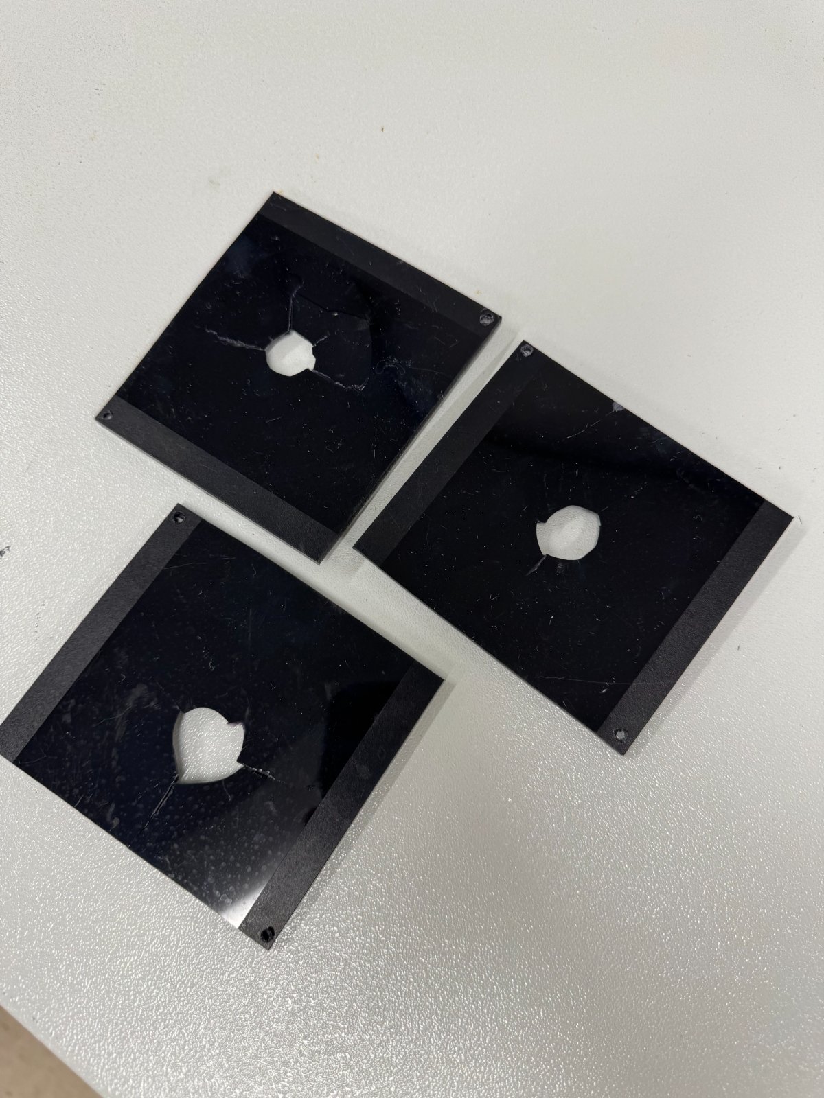 Three polycarbonate plates after multiaxial impact testing