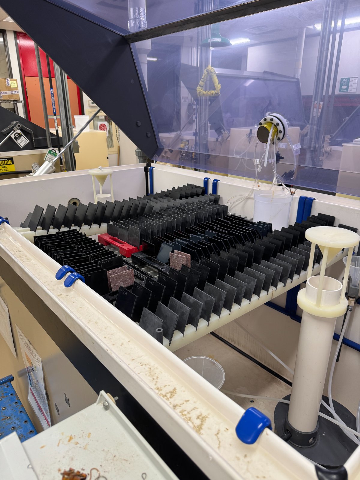Polycarbonate samples racked inside a salt fog test chamber