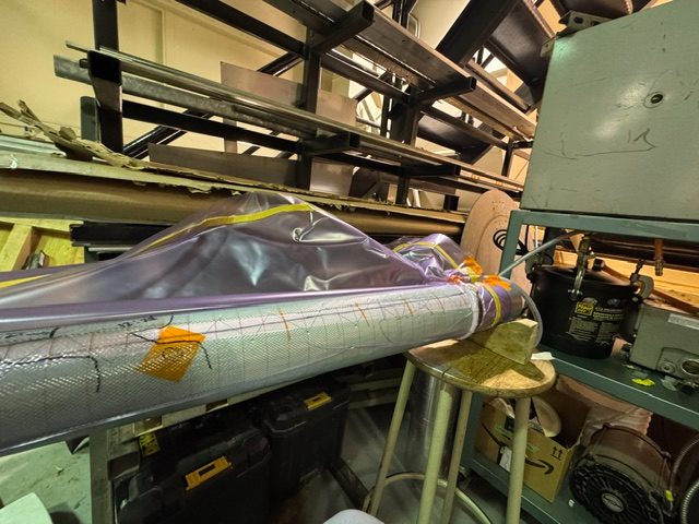 A composite body tube under vacuum bagging in the UBC Rocket shop